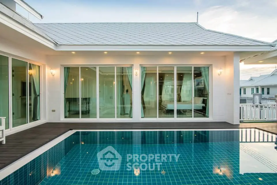 Luxurious modern villa with private pool and elegant glass facade, perfect for serene living.