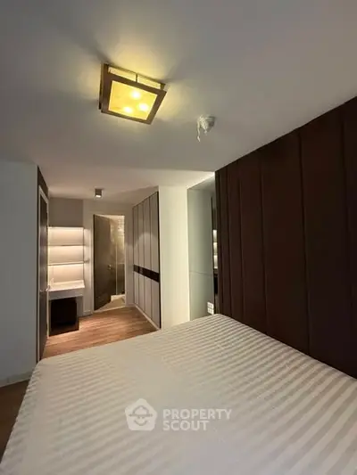 Modern bedroom with ensuite bathroom and stylish lighting