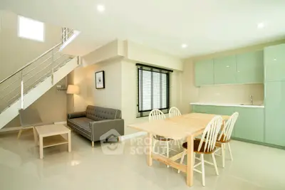 Modern open-plan living room with sleek kitchen and stylish furniture