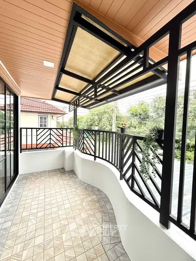 Spacious balcony with modern railing and tiled floor, perfect for relaxation.