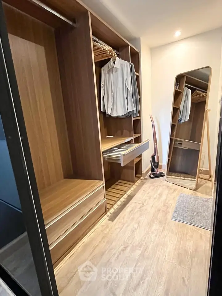 Spacious walk-in closet with wooden finish and full-length mirror