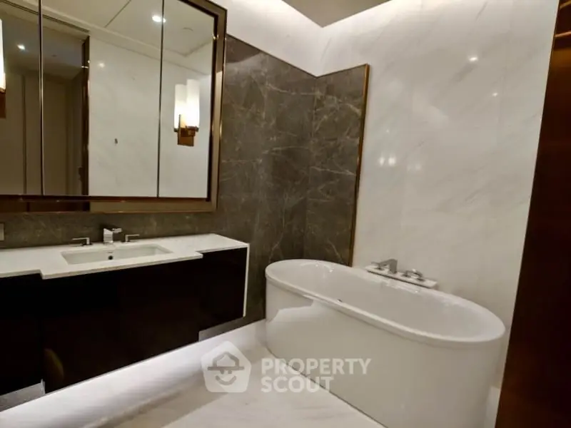 Luxurious modern bathroom with elegant marble finishes and a sleek freestanding bathtub.