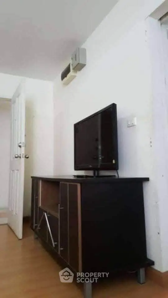 Modern living room with sleek TV stand and wall-mounted air conditioner.