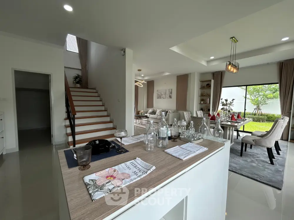 Luxurious open-plan living room with elegant decor and garden view