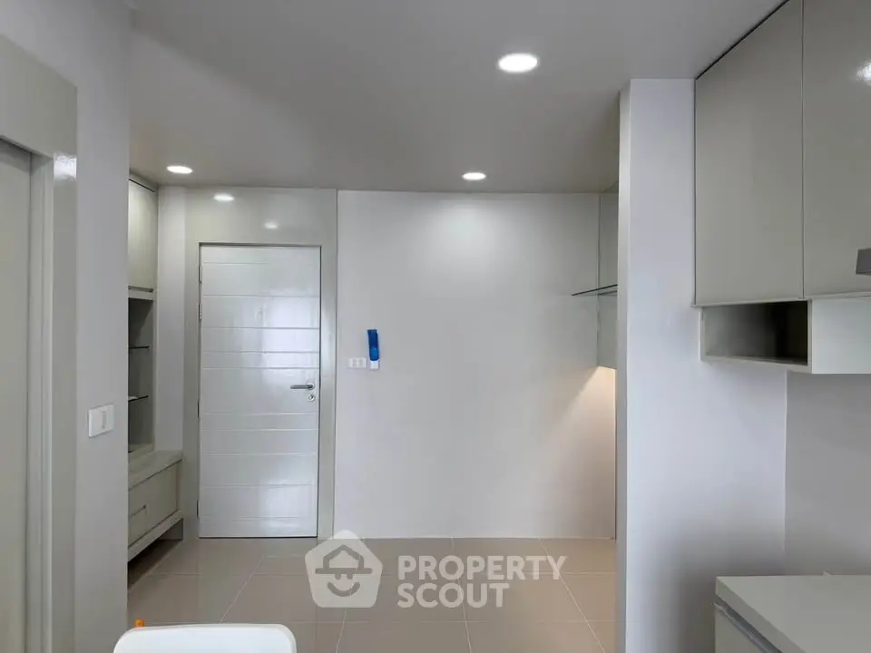 Modern minimalist interior with sleek cabinetry and neutral tones, perfect for contemporary living.