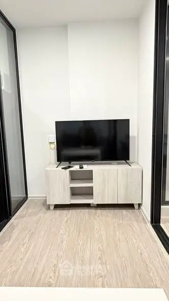Modern living room with sleek TV stand and large flat-screen TV