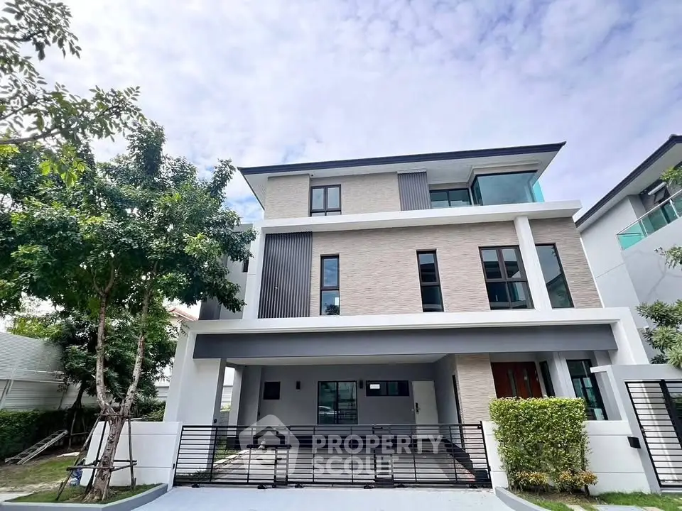 Modern three-story house with sleek design and spacious driveway in a serene neighborhood.
