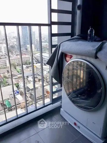 High-rise balcony with city view and modern washing machine, perfect for urban living convenience.
