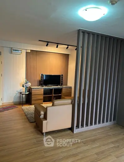 Modern living room with stylish partition and wooden flooring