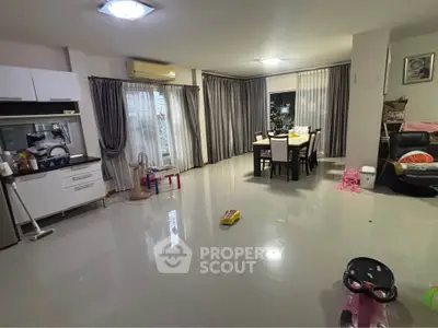 Spacious living room with dining area and modern kitchen in open layout