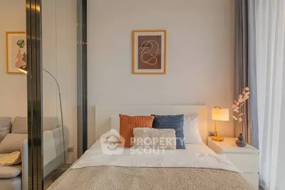 Modern bedroom with stylish decor and cozy ambiance, featuring a comfortable bed and elegant lighting.