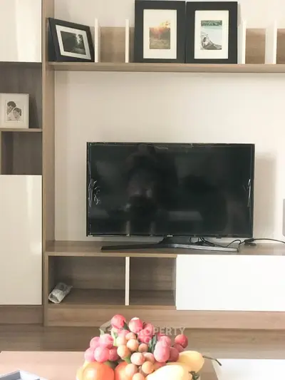 Modern living room with sleek TV unit and decorative shelving