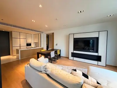 Modern open-plan living room with sleek kitchen and stylish decor