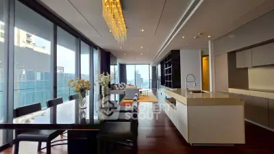 Luxurious open-plan kitchen and living area with city views and elegant chandelier.
