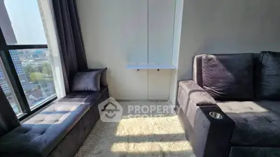 Modern living room with plush seating and city view, perfect for relaxation and entertainment.