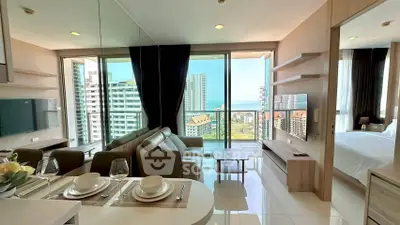 Modern condo living room with stunning city and sea view, open layout, and elegant decor.