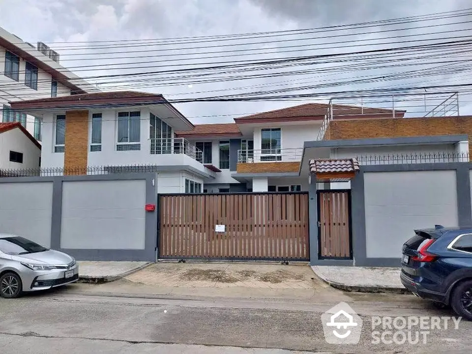 Modern two-story house with gated entrance and spacious driveway