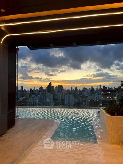 Luxurious rooftop infinity pool with stunning city skyline view at sunset.