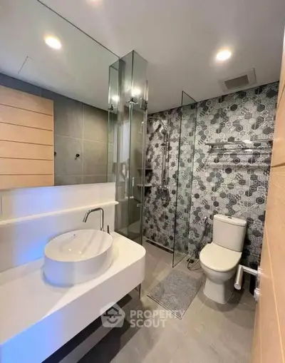 Modern bathroom with stylish sink and glass shower enclosure