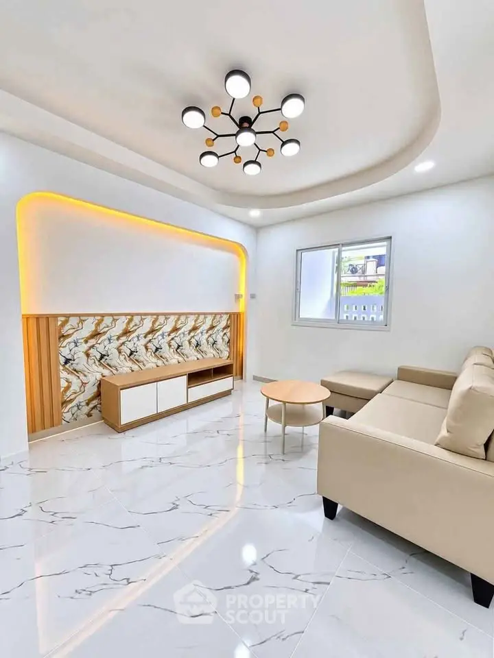 Modern living room with elegant lighting and marble flooring