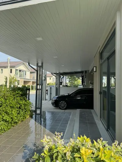 Modern carport with sleek design and luxury vehicle in suburban neighborhood