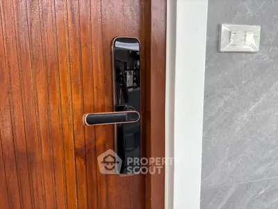 Modern smart lock on wooden door with sleek design and security features