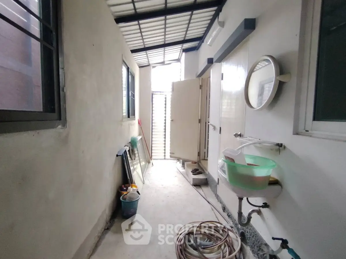 Functional utility area with sink and storage, ideal for practical household tasks.