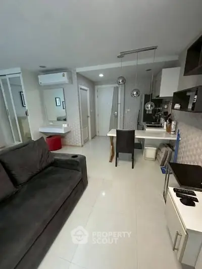 Modern compact living room with open kitchen layout and stylish decor