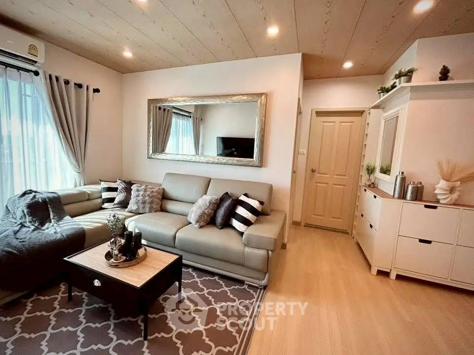 Stylish living room with modern decor, cozy seating, and elegant lighting.