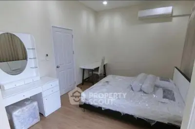 Spacious bedroom with modern furniture and air conditioning in a cozy apartment.