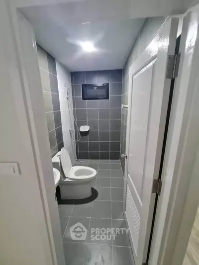 Modern bathroom with sleek gray tiles and minimalist design