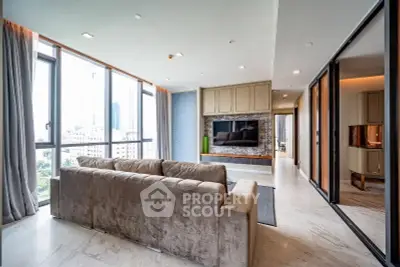 Luxurious modern living room with large windows and elegant decor in high-rise apartment.