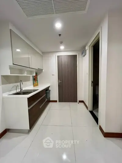 Modern kitchen with sleek cabinetry and minimalist design in a contemporary apartment.
