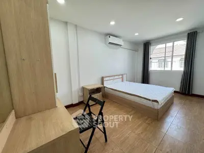 Spacious bedroom with modern furnishings and natural light