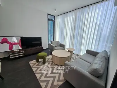 Modern living room with stylish furniture and floor-to-ceiling windows