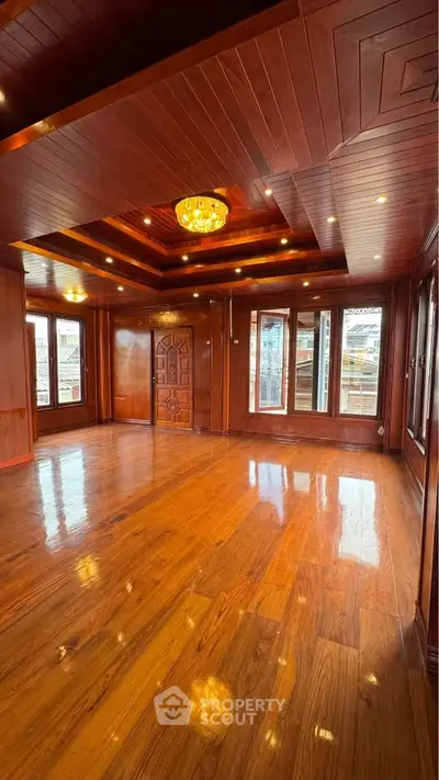 Luxurious wooden interior living room with polished floors and elegant ceiling design.