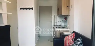 Cozy studio apartment with compact kitchen and stylish decor