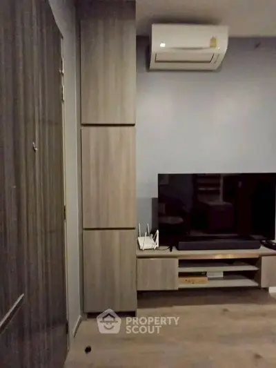 Modern living room with sleek furniture and air conditioning unit