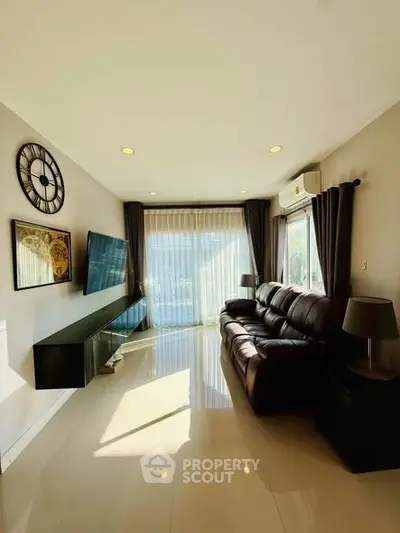 Modern living room with sleek design and ample natural light