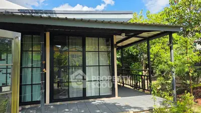 Charming garden view house with spacious balcony and modern glass doors