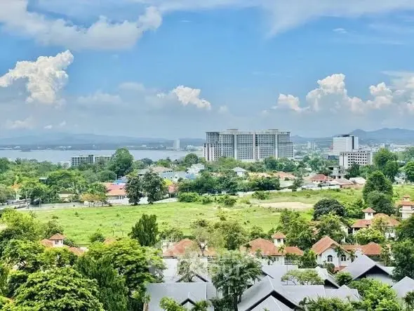 Stunning panoramic view of lush greenery and city skyline, perfect for serene living.