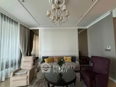 Elegant living room with stylish chandelier and cozy seating area, perfect for relaxation and entertaining.
