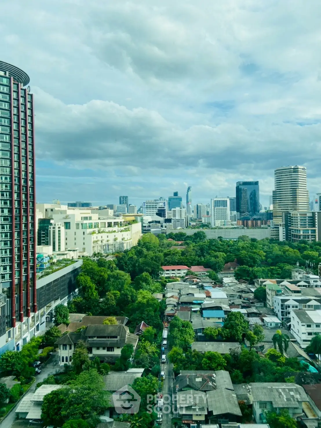 Stunning cityscape view with lush greenery and modern skyscrapers, perfect for urban living enthusiasts.