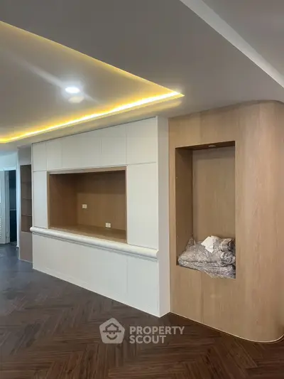 Modern living room with built-in shelving and wood accents