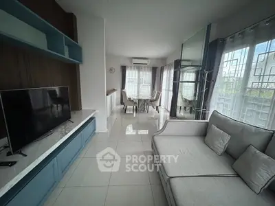 Spacious modern living room with elegant decor and large windows for natural light.