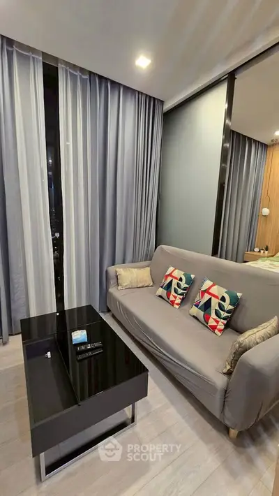 Modern living room with stylish sofa and sleek coffee table in a cozy apartment setting.