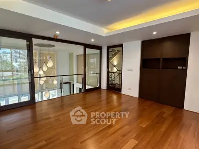 Spacious modern living room with wooden flooring and stylish lighting