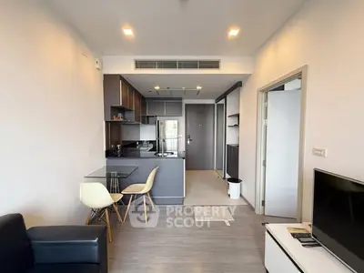 Modern open-plan kitchen and living area with sleek design and natural light.