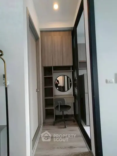 Modern study nook with sleek desk and mirror in compact apartment