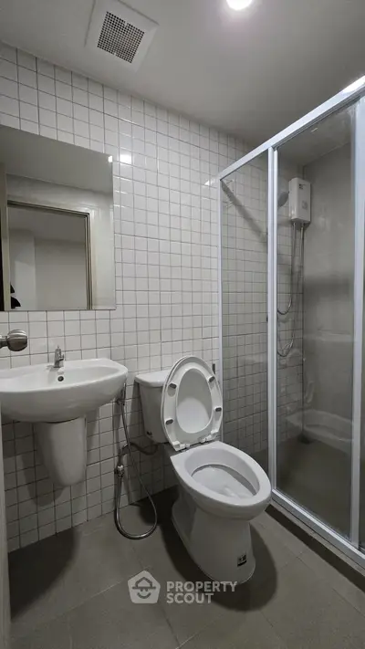 Modern bathroom with shower enclosure and sleek white fixtures